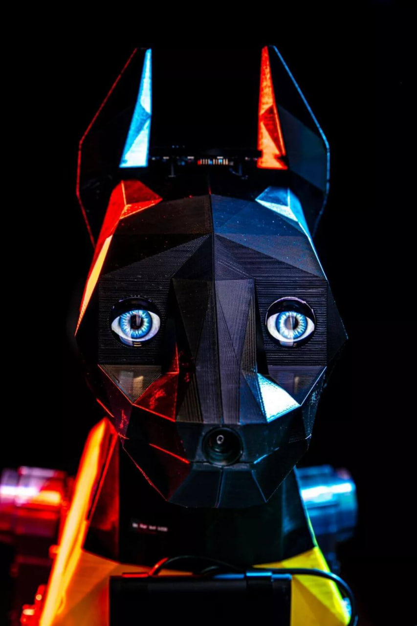 Astro looking forward with blue eyes under red and blue lighting