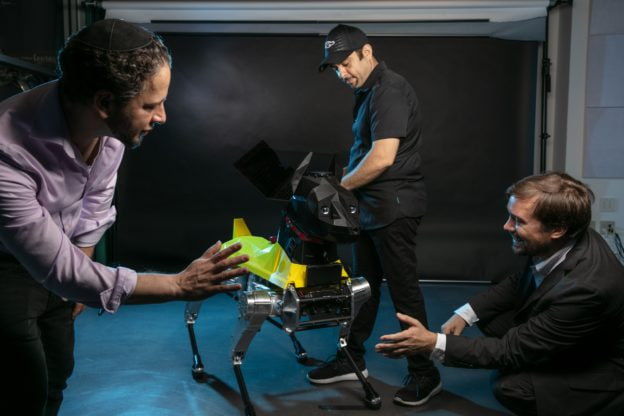 Researchers working with Astro in a studio